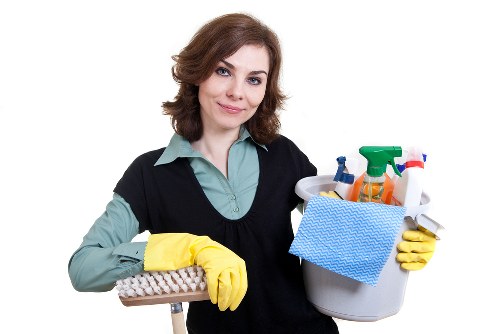Local cleaner preparing bedding and surfaces in a Maida Vale apartment